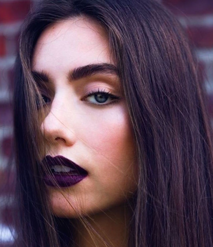 dark purple lipstick on brunette woman