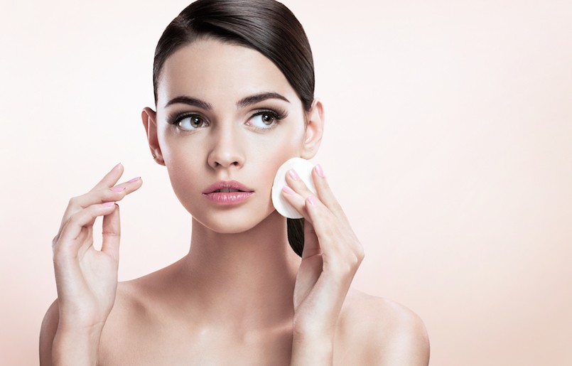 Beautiful brunette lady removing makeup from her face, skin care concept : photoset of attractive brunette girl on beige background