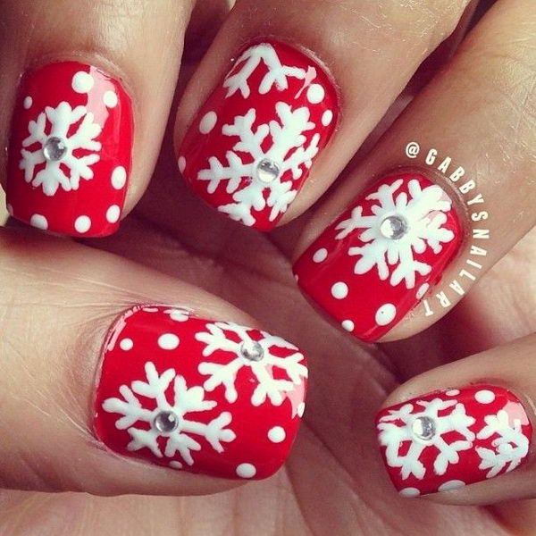 snowflake nail art on red manicure
