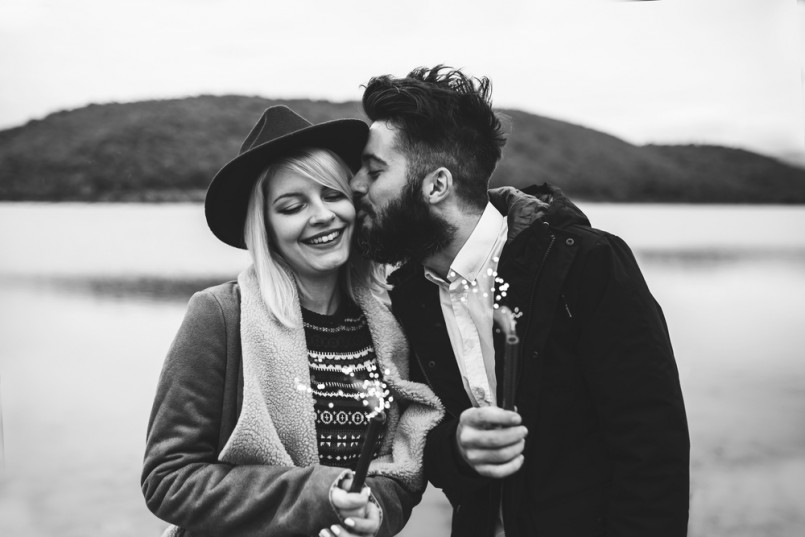 Young couple having fun and celebrating life, holding sprinkles and kissing