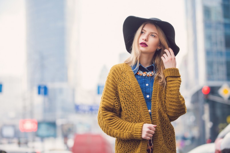 fashionable young woman posing outside in a city street