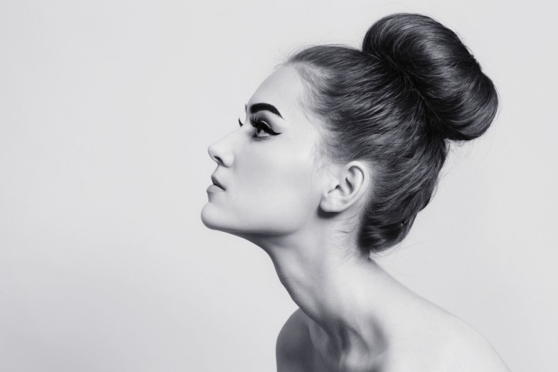 Black and white shot of young beautiful girl with hair bun