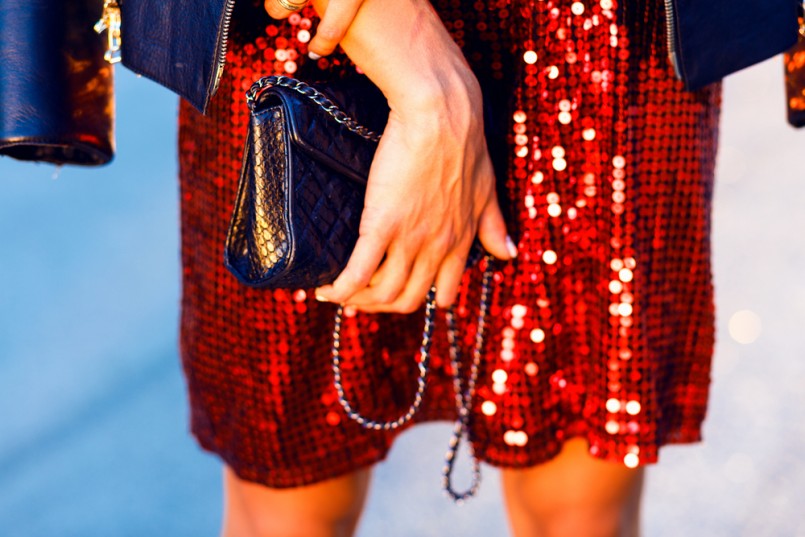 Close-up image of bright party woman's clothes,stylish hipster girl,denim jacket,jewelry, fashion,teen,cool accessories,purse, hat, sunglasses,amazed,vintage style,urban city background,black handbag