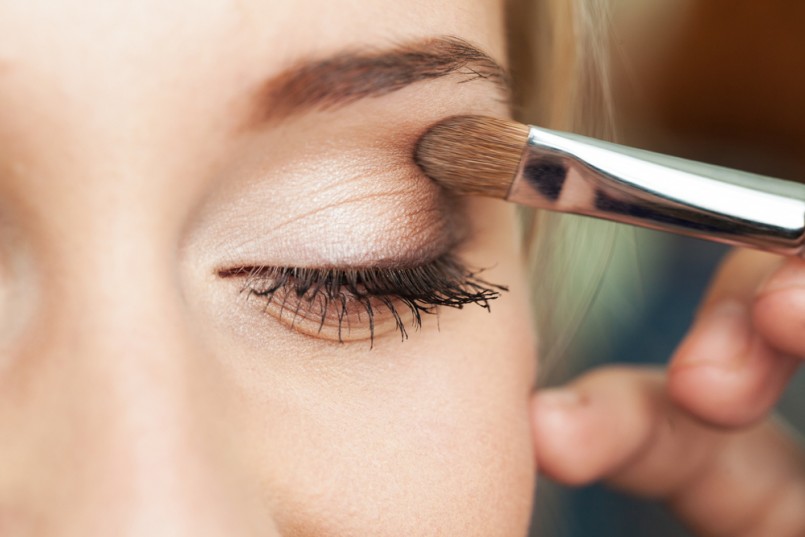 Eye makeup woman applying eyeshadow powder