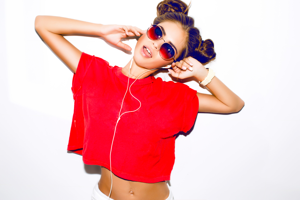 Indoor fashion autumn portrait of elegant sexy woman in luxury bright glamour outfit,red lips,red crop top and trendy sunglasses