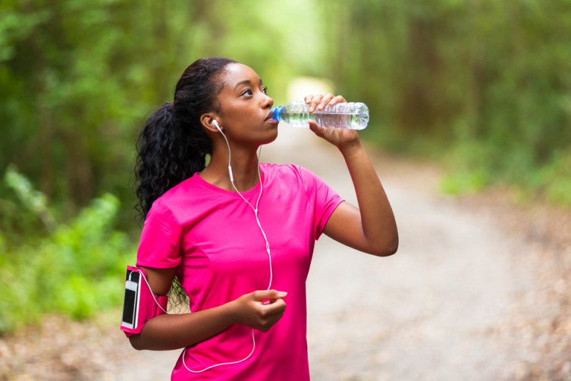 African american woman jogger drinking water - Fitness, people and healthy lifestyle