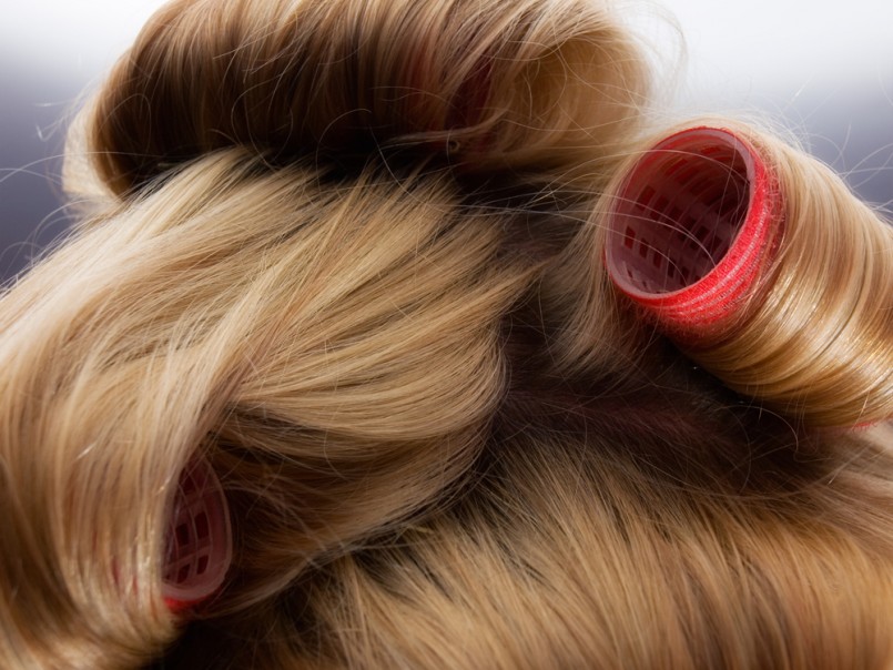 Closeup of blond hair during hair dressing with curler