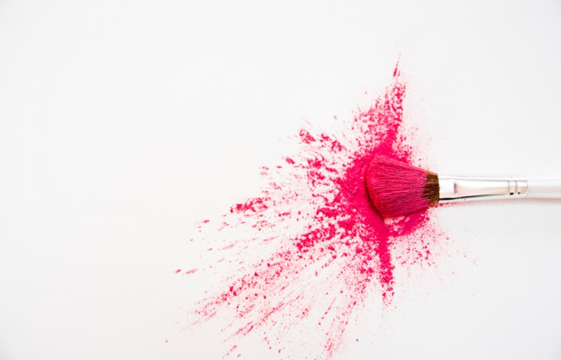 Makeup Brushes on White Background with Colorful Pigment Powder