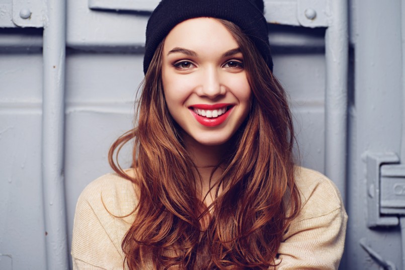 Portrait of a beautiful brunette girl outdoors in hat, lifestyle
