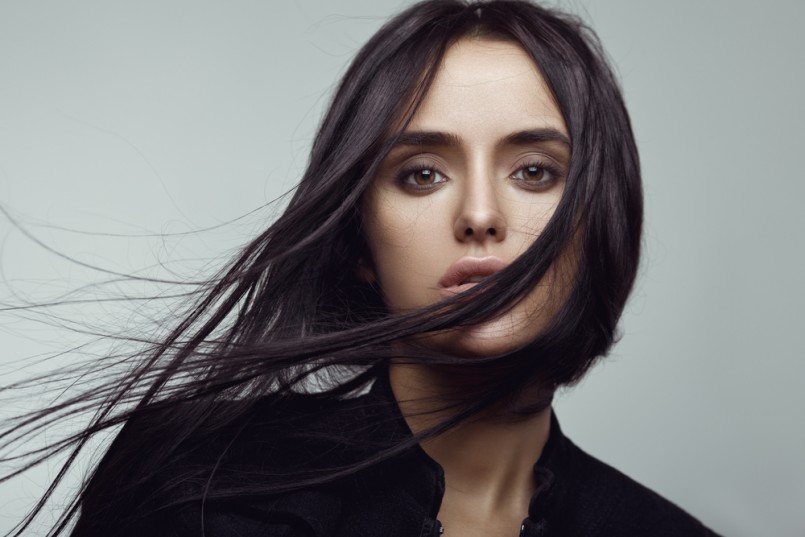 Beauty portrait of brunette girl with flying hair. Magnificent hair