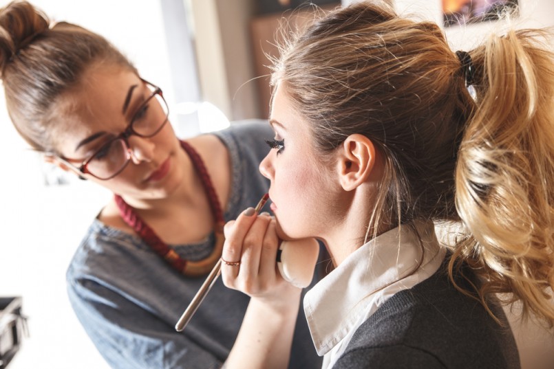 Make-up artist work on her friend.Real people.