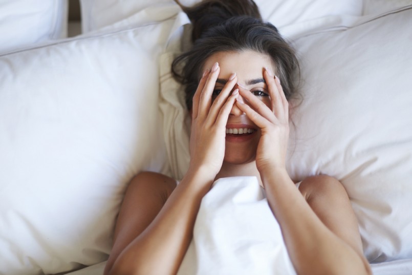 She is little shy woman in bed