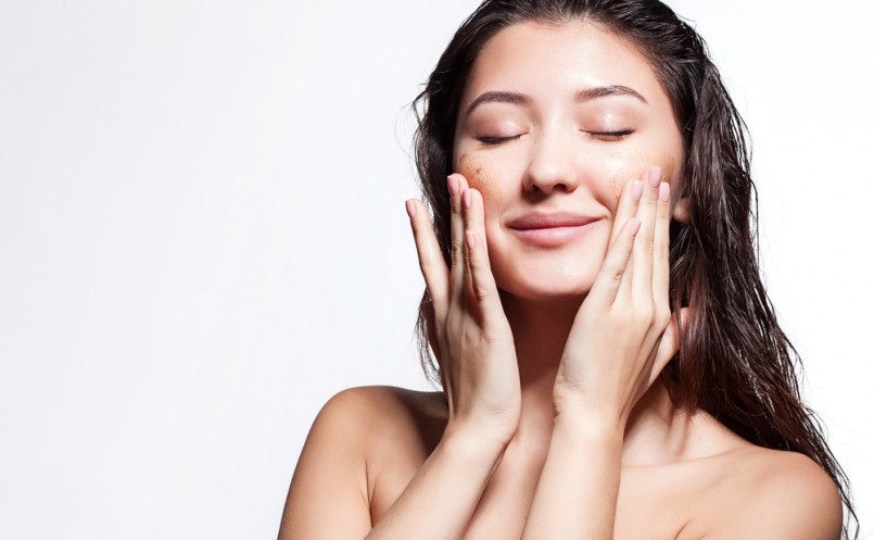 Woman happy to scrub cleanses the skin on a white background isolated