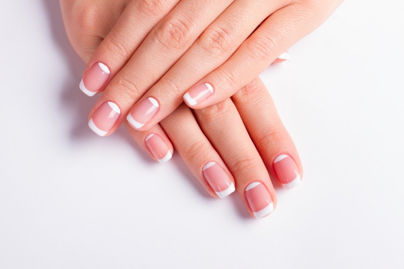 Beautiful moon french manicure. Neat manicure on a white background.