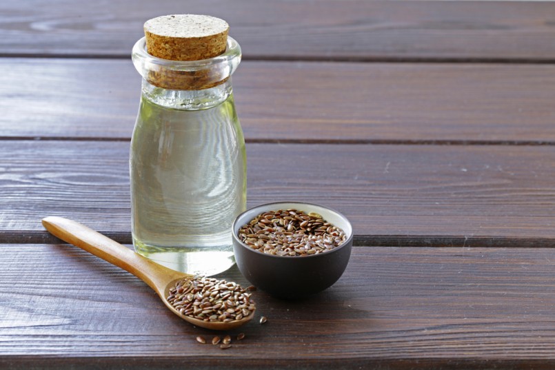 flax seed oil in glass bottle on a wooden table