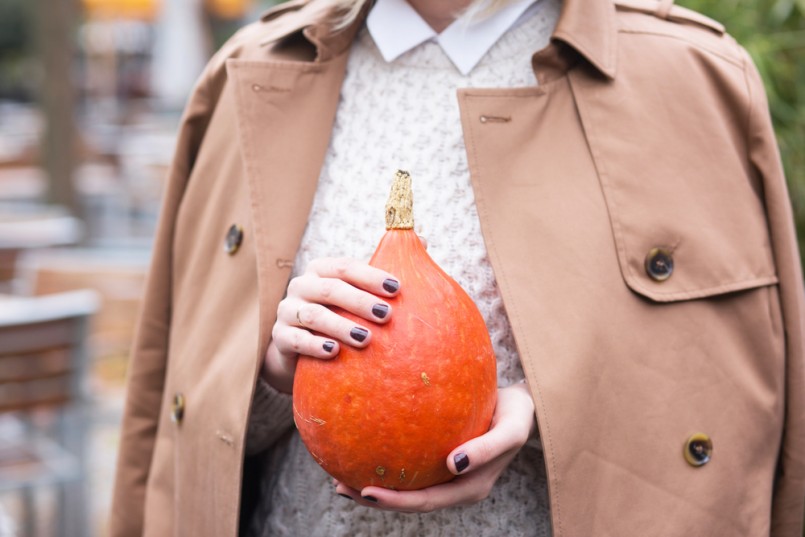 modern and stylish young women holding a hokkaido pumpkin in her hands