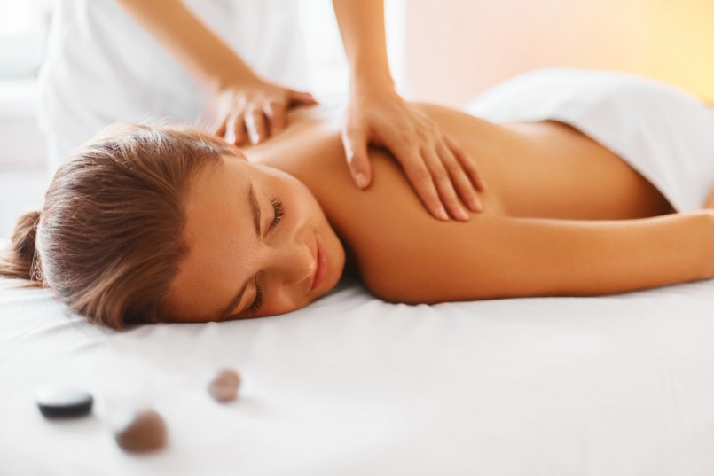 Spa woman. Female enjoying relaxing back massage in cosmetology spa centre. Body care, skin care, wellness, wellbeing, beauty treatment concept