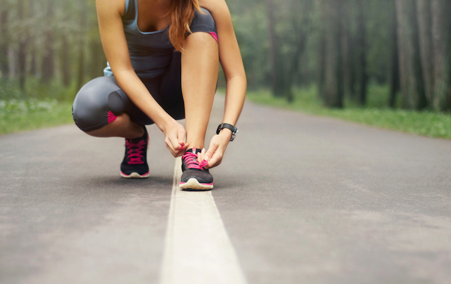 young-sporty-woman-preparing-to-run-in-early-foggy-morning-in-the-beautiful-nature-forest-wellness-concept
