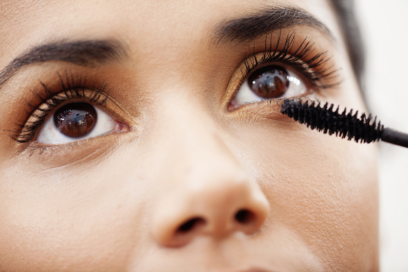 Woman applying mascara