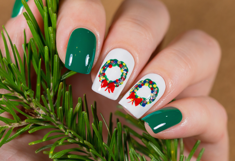 Christmas Nail art manicure. Winter Holiday style bright Manicure Design. Christmas decorations and snowflakes. Nail Polish. Beauty hands. Trendy Stylish Silver and Blue Colorful Nails, Nailpolish