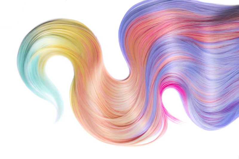Multicolored Hair isolated over white background. Shiny Healthy colored hair lock closeup, Colorful Dyed hair, pastel colors